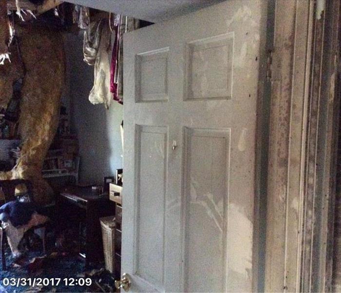 sooty deposit on door of fire damaged room