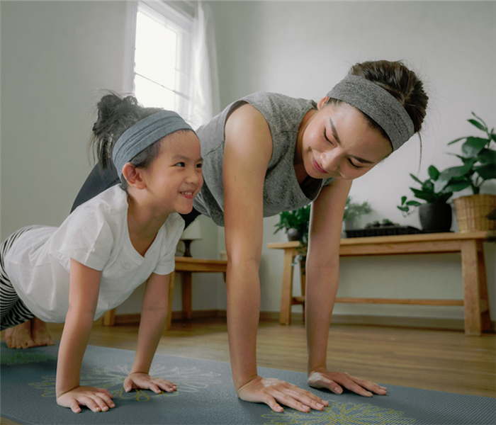 a mother and daughter working out together at home